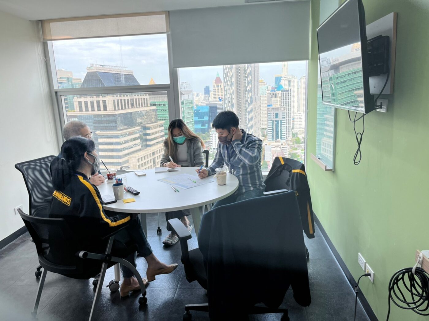 Planning session in a meeting room overlooking Bangkok